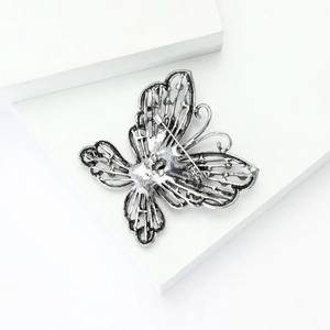 Detail of vintage hollow butterfly brooch back with secure pin clasp mechanism