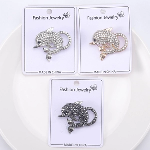 Three dolphin brooches in silver, rose gold and black with sparkling rhinestones