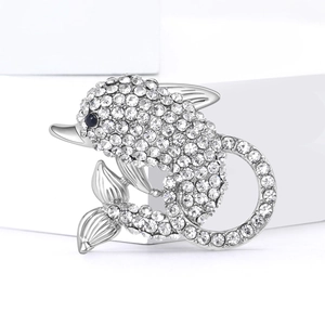 Luxurious dolphin brooch with sparkling clear crystals and a blue gemstone eye
