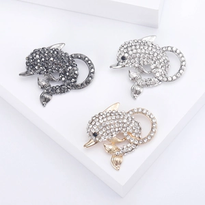 Sparkling dolphin brooches with inlaid crystals in gold, silver, and black finishes