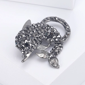 Detailed macro of a dolphin brooch with dark grey rhinestones on gunmetal finish