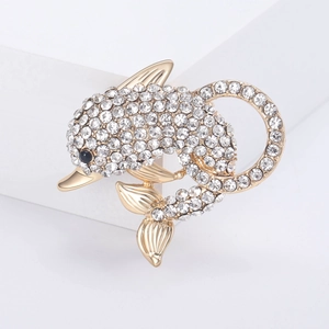 Detail of a dolphin brooch with pavé-set white rhinestones and gold plating