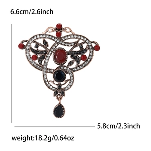 Vintage palace style alloy brooch with red rhinestones and measurements 6.6x5.8cm