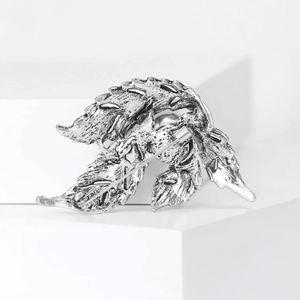 Elegant vintage silver leaf brooch with pearl details and textured metal finish
