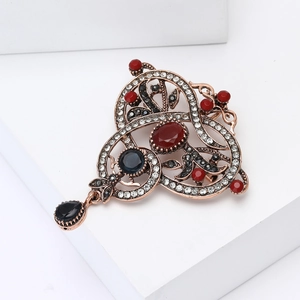 Vintage palace style alloy rhinestone brooch with red gemstone and black drop pendant