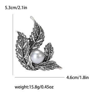 Elegant vintage silver leaf brooch with grey rhinestones and a white pearl, 5.3x4.6cm size