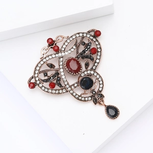 Vintage palace style alloy brooch with red rhinestones and black crystal teardrop