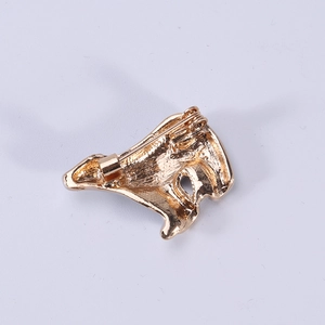 Golden alloy polar bear brooch showing the secure pin closure and matte metal texture