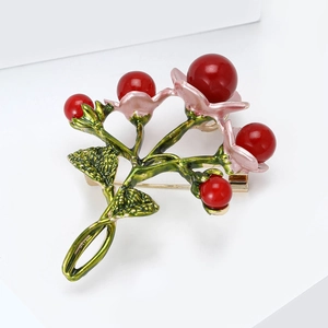 Handcrafted floral brooch with pink enamel petals and red pearl accents on gold base