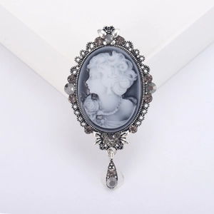Vintage silver cameo brooch with grey resin portrait and sparkling rhinestone accents