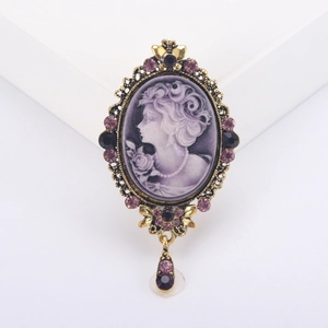 Vintage cameo brooch with purple female profile relief and antique gold rhinestone frame