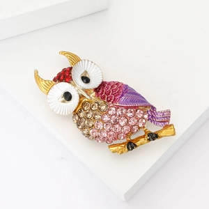 Elegant owl brooch pin with rhinestones and colorful enamel on a golden branch