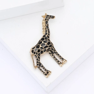 Elegant gold-tone giraffe brooch with black enamel spots and sparkling rhinestones