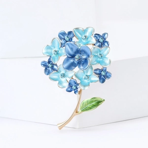 Exquisite blue hydrangea flower brooch with rhinestones and gold stem on white background
