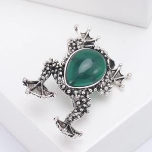 Retro frog brooch with green pear-shaped gemstone and silver metal textured detail