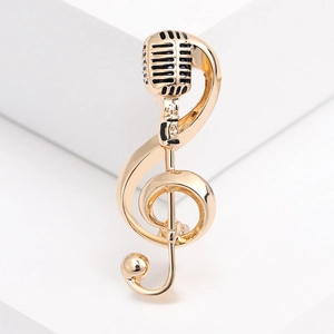 Elegant gold musical note G-clef brooch with vintage microphone design on white stand