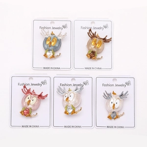 Detail of five colorful owl brooches with smooth oil-drop alloy finish and display cards