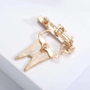 Detailed back view of gold alloy brooch showing sturdy pin clasp and brushed metal texture