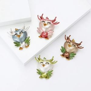 Creative alloy enamel owl brooches in four pearlescent colors on white pedestals
