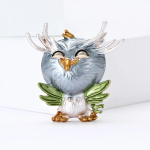 Creative owl enamel brooch with antlers and green wings in a premium metallic finish