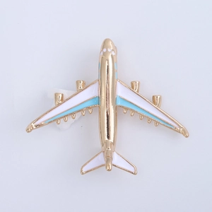 Detail of aircraft brooch badge in gold metal with white and blue enamel filling