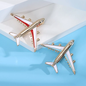 Detail of creative airplane brooches with enamel finish in red and blue color schemes