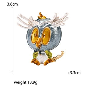 Chic alloy owl brooch with yellow eyes and green leaves, dimensions 3.8cm by 3.3cm