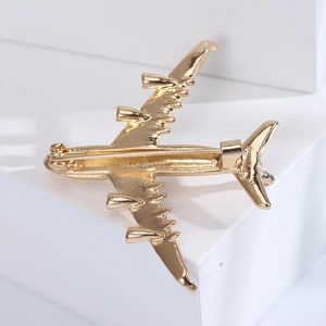 Detailed back view of a gold aircraft brooch showing secure pin clasp and metal finish