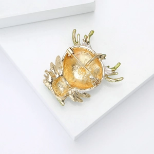 Detailed back view of golden alloy owl brooch showing secure metal pin and safety clasp