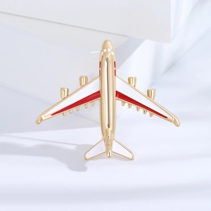Minimalist gold-plated airplane brooch with red and white enamel wings for accessories