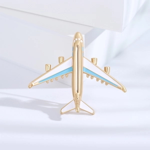 Fashionable gold airplane brooch with blue enamel inlay for suits and accessories