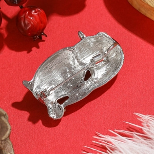 Back view of cute penguin alloy brooch with silver metal finish on festive red background