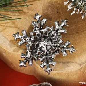 Snowflake brooch with rhinestones and vintage silver finish shown from the back side
