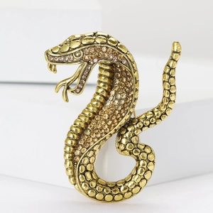 Vintage gold snake brooch with amber rhinestones and detailed scale texture