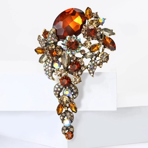 Macro shot of vintage amber crystal brooch with intricate floral details and bronze finish