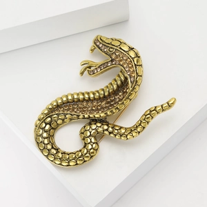 Fashionable cobra snake brooch with amber rhinestones on vintage gold metal finish
