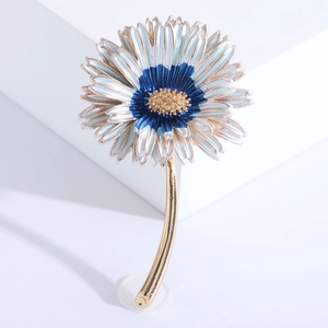 Macro detail of enamel daisy brooch featuring gradient petals and golden textured flower core