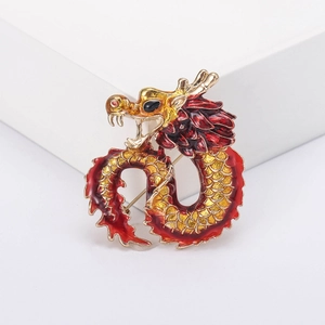 Golden dragon brooch with red enamel details and black gemstone eye for suit lapel