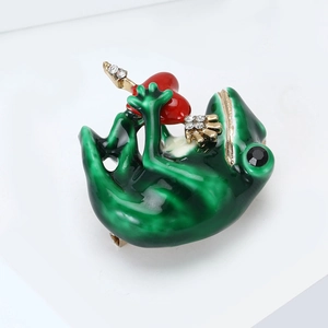 Detail of frog brooch with green enamel, a red heart and sparkling rhinestones