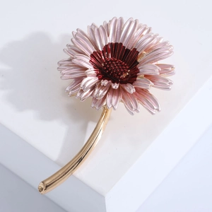 Elegant multi-layered pink daisy brooch with enamel petals and gold stem on white stand