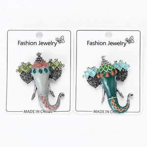 Detailed macro view of bohemian style elephant head brooches with enamel and crystals