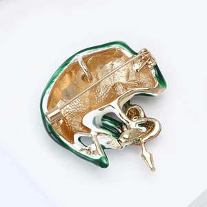 Detail view of the gold-plated metal back and safety pin clasp of the enamel brooch