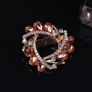Macro shot of vintage crystal floral brooch with amber gemstones and colorful rhinestones