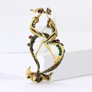 Macro shot of vintage gold alloy brooch featuring kissing lovers with blue rhinestones