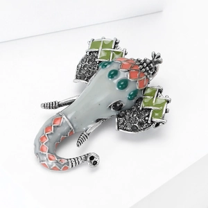 Close-up of vintage elephant brooch with grey enamel, rhinestones and ethnic patterns