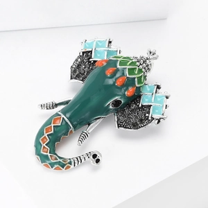 Detail of colorful enamel elephant brooch with sparkling black rhinestones and silver tusks