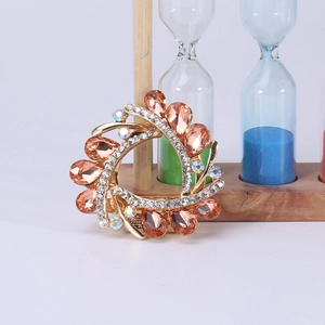 Detailed macro view of vintage gold ring brooch with amber crystals and small rhinestones