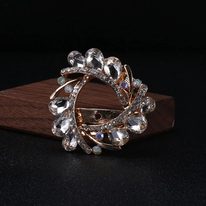 Detail of vintage gold crystal brooch with teardrop stones and secure back clasp