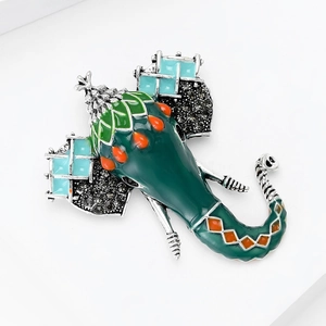 Detailed view of elephant brooch with green enamel and crystal embellishments