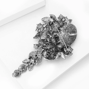 Detailed macro view of the vintage metal floral brooch back with silver finish clasp